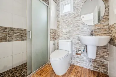 a bathroom with a toilet and a sink at Winrisa Place in Nai Yang Beach