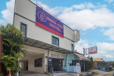a hotel with a sign on the side of it at Winrisa Place in Nai Yang Beach