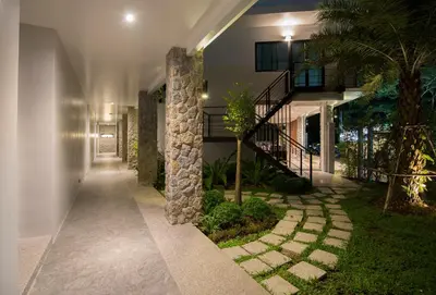 a hallway of a house with a walkway at Pumeria Resort Phuket - SHA Plus in Bang Tao Beach
