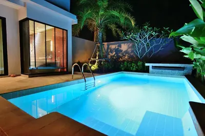 a swimming pool in a house with plants at Pumeria Resort Phuket - SHA Plus in Bang Tao Beach