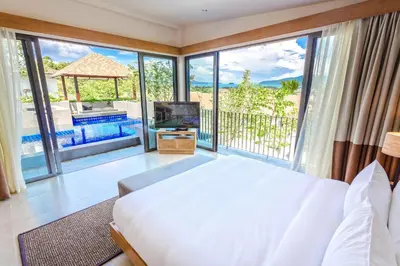 a bedroom with a large bed and a large window at CASABAY Luxury Pool Villas by STAY in Rawai Beach