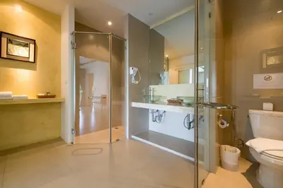 a bathroom with a shower and a toilet at Amala Grand Bleu Resort Hilltops - SHA in Kamala Beach