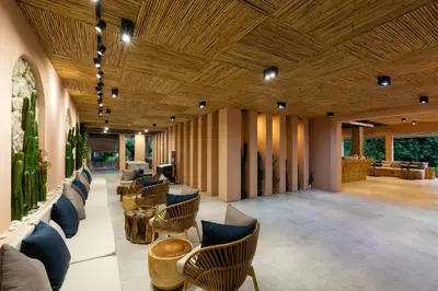 a lobby with couches and chairs and a wooden ceiling at Amala Grand Bleu Resort Hilltops - SHA in Kamala Beach