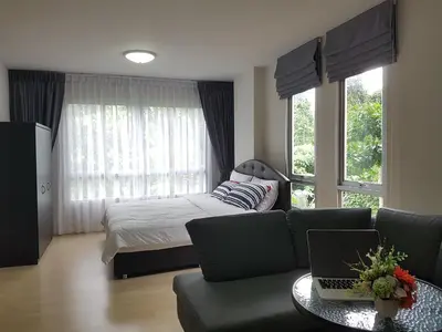 a bedroom with a couch and a bed with a laptop at Dcondo Kathu Patong Phuket by Jack in Kathu
