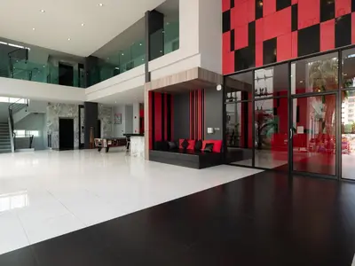 a lobby of a building with red and black at Neon Patong in Patong Beach