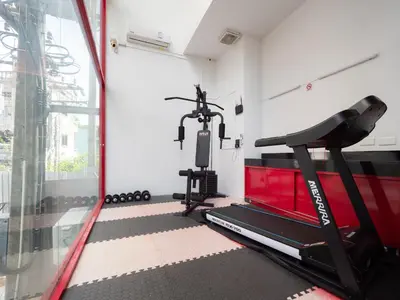 a room with a gym with a treadmill at Neon Patong in Patong Beach