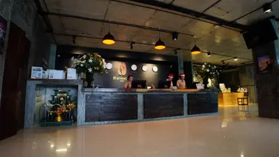 a bar in a restaurant with people sitting at a counter at Maneetel Krabi Beachfront-SHA Plus in Ao Nang Beach