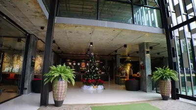 a christmas tree in the middle of a building at Maneetel Krabi Beachfront-SHA Plus in Ao Nang Beach