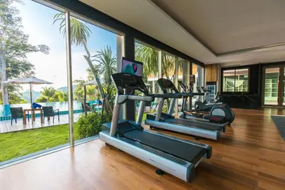 an exercise room with treadmills and a gym at Wyndham Grand Phuket Kalim Bay in Patong Beach