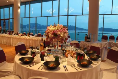 a table set up for a wedding with flowers on it at Wyndham Grand Phuket Kalim Bay in Patong Beach