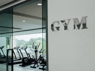 a gym with treadmills and ellipticals in a building at Aqua Resort Phuket - Near Beach and Chalong Pier in Rawai Beach