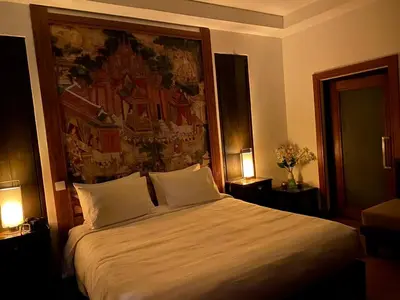 a bedroom with a large bed with two pillows at Tukonnee Villas Koh Yao Noi in Ko Yao Noi