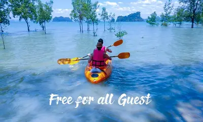 a person in a kayak in the water at Tukonnee Villas Koh Yao Noi in Ko Yao Noi