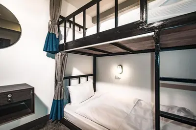 a bedroom with two bunk beds and a mirror at Balcony Party Hostel - 18-40 in Ao Nang Beach