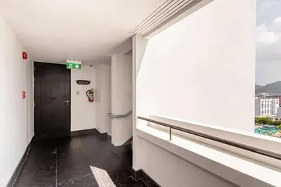 an empty hallway with a door and a window at Andaman Sea View Apartment - Patong Beach in Patong Beach