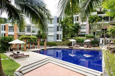 a large swimming pool in front of a building at Kamala Hills Serviced Apartments in Kamala Beach