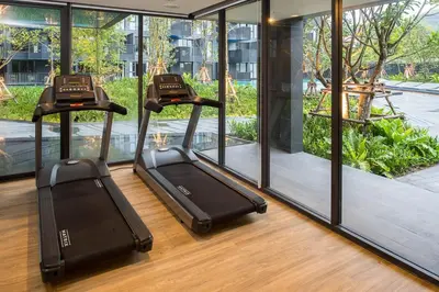 two treadmill machines in a room with windows at The Deck Condominium Patong Beach in Patong Beach
