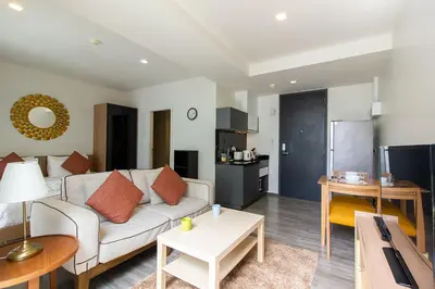 a living room with a couch and a table at The Deck Condominium Patong Beach in Patong Beach