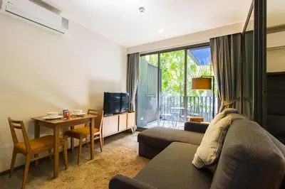 a living room with a couch and a table at The Deck Condominium Patong Beach in Patong Beach