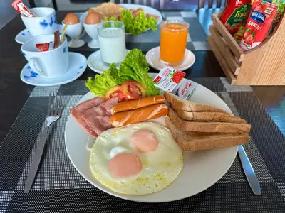 a plate of breakfast food with eggs bread and toast at Sunset Bay View Phuket in Patong Beach