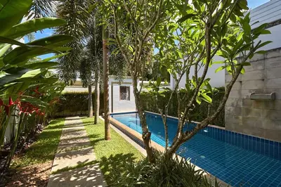 a swimming pool in the middle of a yard with trees at Villa Oxygen - Bangtao Beach in Bang Tao Beach