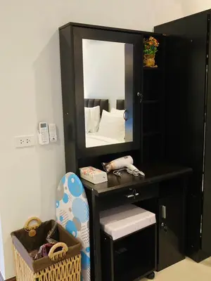 a bedroom with a black vanity with a mirror at Boutique Resort Private Pool Villa - SHA Extra Plus in Thalang