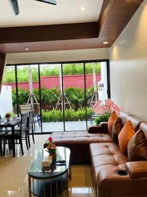 a living room with a couch and a table at Boutique Resort Private Pool Villa - SHA Extra Plus in Thalang