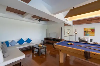 a living room with a pool table and a couch at Vichuda Hills by RESAVA in Layan Beach