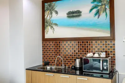 a kitchen with a sink and a microwave at The Lucky Beach Ao Nang in Ao Nang Beach