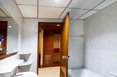 a bathroom with a tub and a toilet and a sink at Kata Sun Beach Hotel in Kata Beach