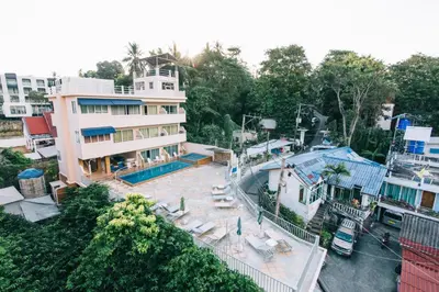 an aerial view of a building with a swimming pool at Kata Sun Beach Hotel in Kata Beach