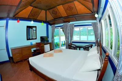 a bedroom with a large bed and a table at Phi Phi View Point Resort in Phi Phi Don