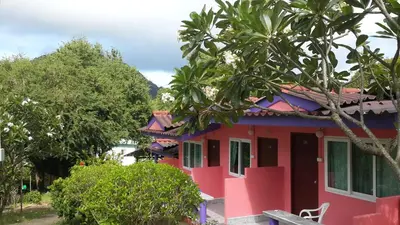 a pink house with a tree in front of it at Phi Phi View Point Resort in Phi Phi Don