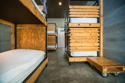 a bedroom with two bunk beds and a staircase at ChillHub Hostel Phuket in Bang Tao Beach