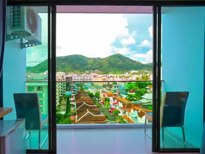 a view of a city from a large window at Phoenix Grand Patong in Patong Beach