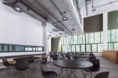 a large room with tables and chairs and windows at Phoenix Grand Patong in Patong Beach