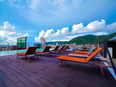 a group of chairs sitting on top of a roof at Phoenix Grand Patong in Patong Beach
