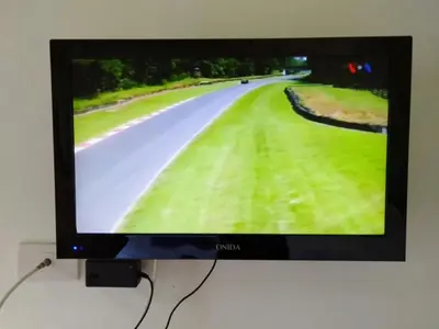 a flat screen tv hanging on a wall at Six Pack Cottage in Chalong
