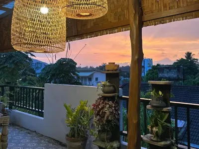 a balcony with a chandelier and potted plants at The Luna in Nai Yang Beach