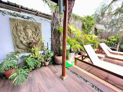 a balcony with plants and a statue on a wall at The Luna in Nai Yang Beach