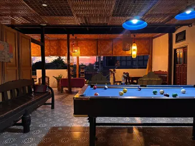 a living room with a pool table and a couch at The Luna in Nai Yang Beach