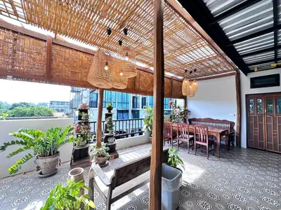 a patio with a table and chairs on a balcony at The Luna in Nai Yang Beach