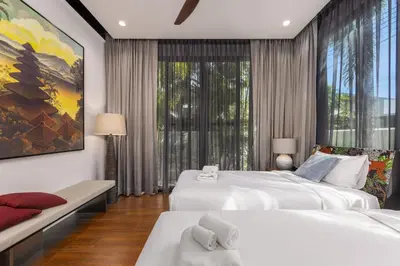a bedroom with two beds and a large window at VILLA PULAU 3 bedroom Baan Bua Estate in Nai Harn Beach
