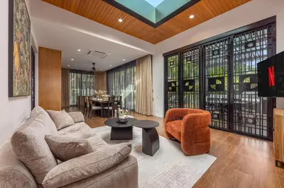 a living room with a couch and chairs and a table at VILLA PULAU 3 bedroom Baan Bua Estate in Nai Harn Beach