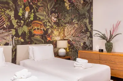 a bedroom with two beds and a wall mural at VILLA PULAU 3 bedroom Baan Bua Estate in Nai Harn Beach