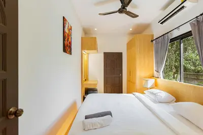 a bedroom with a white bed and a window at Happy Family Villa 2 in Chalong
