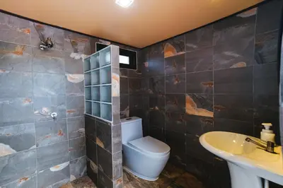 a bathroom with a toilet and a sink at Happy Family Villa 2 in Chalong