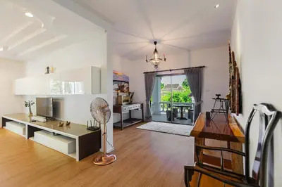 a large living room with a desk and a fan at Happy Family Villa 2 in Chalong