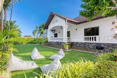 a house with pillows on the lawn at Happy Family Villa 2 in Chalong