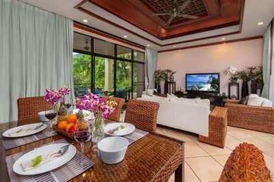 a living room with a table and a couch at Villa Raas 3BR Private PoolNaiharn beach in Nai Harn Beach
